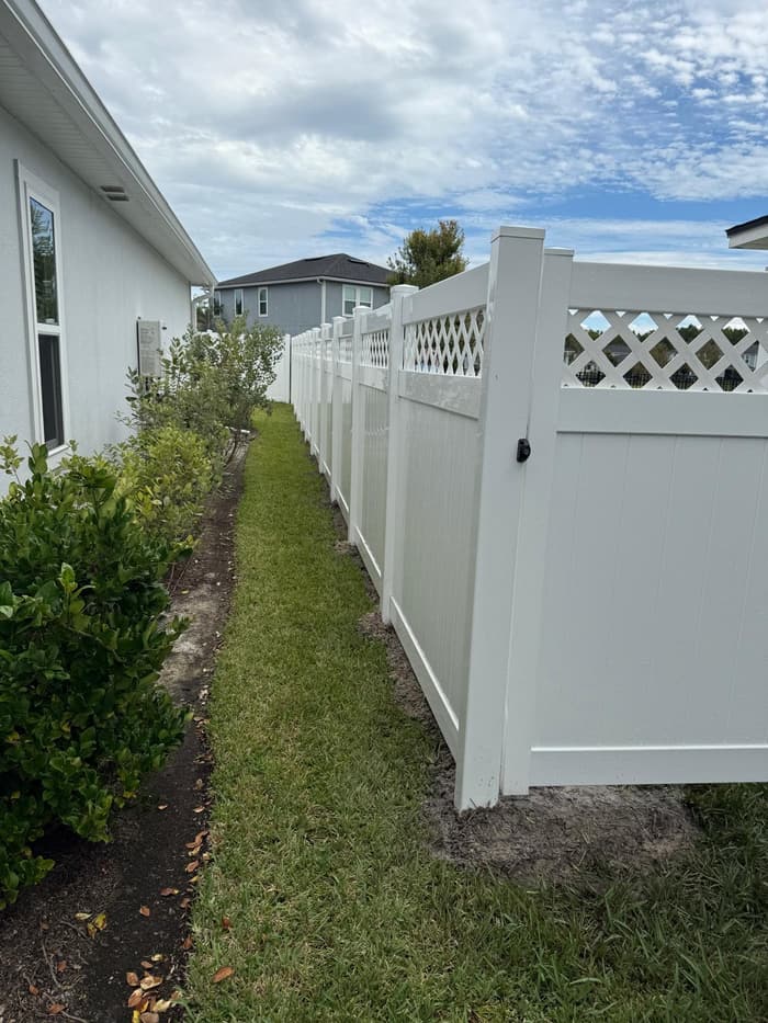 Vinyl fence with a decorative lattice-top accent and gate